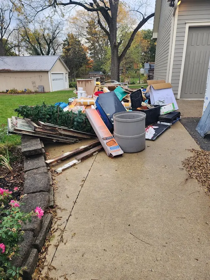 Dumpster being loaded with debris for 12 Yard Dumpster Rental in Vilonia